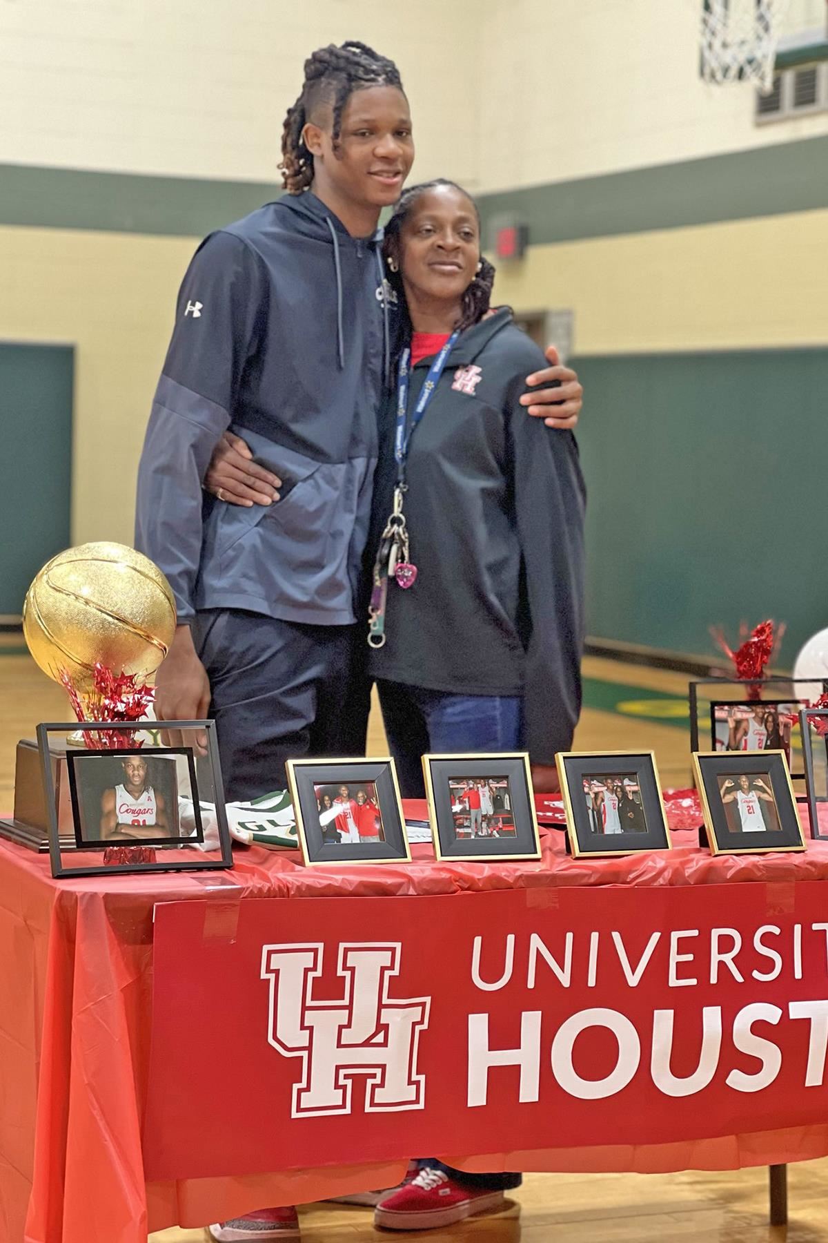 Cy Falls High School senior Joseph Tugler, left, signed a letter of intent to play basketball at the University of Houston.